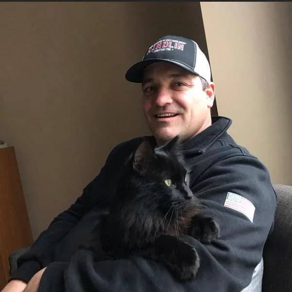 Chris Handlin with company cat